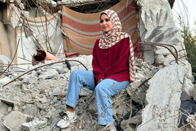 Project HOPE Gaza Human Resources Coordinator Nouralhuda Abu Gefra sits in the rubble of her partially damaged house in Gaza, on October 14, 2025.