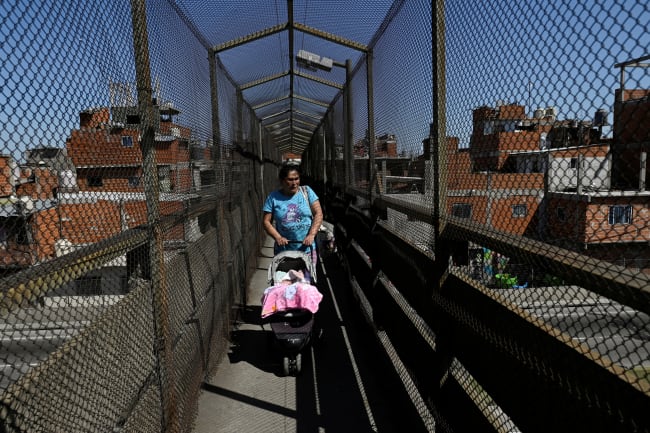 A woman pushes a baby stroller, in Villa Soldati, Argentina, on September 16, 2024.
