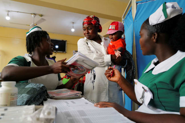 Health workers attend to a mother and her infant at the Mother and Child Hospital, in Kasoa, Ghana, on November 19, 2025.