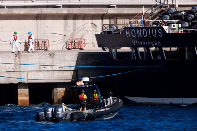 Civil guard members approach the cruise ship MV Hondius, affected by a hantavirus outbreak, on a motorboat, at the port of Granadilla de Abona, Tenerife, Spain, on May 11, 2026.