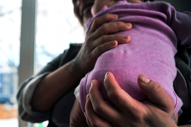 A woman holds her baby at the Sanctum Hospice and Care Home, in Saskatoon, Saskatchewan, Canada, on January 26, 2023.