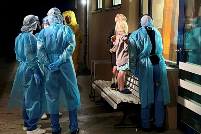 Two children of an American Ebola patient look through a window at their father in the isolation ward, at the Charite hospital in Berlin, Germany, on May 21, 2026.