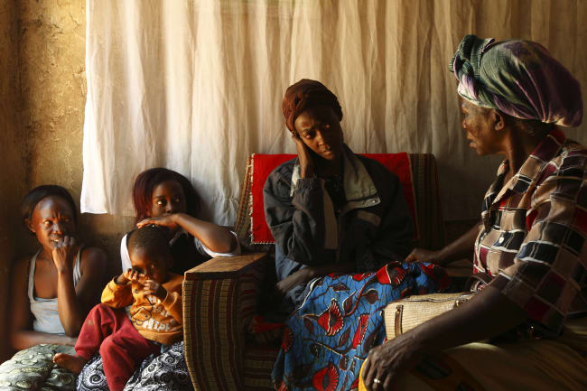 A home-based caregiver visits an HIV/AIDS patient in her home in Matero township, Lusaka, Zambia, on April 17, 2012.