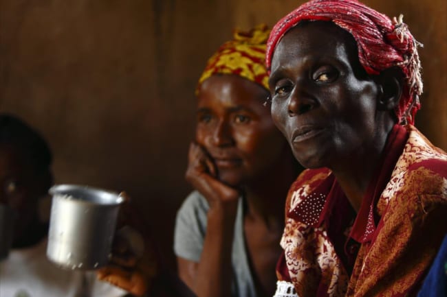 HIV-positive members of a self-help group meet with a caregiver in the village of Michelo, Zambia, on February 23, 2015.