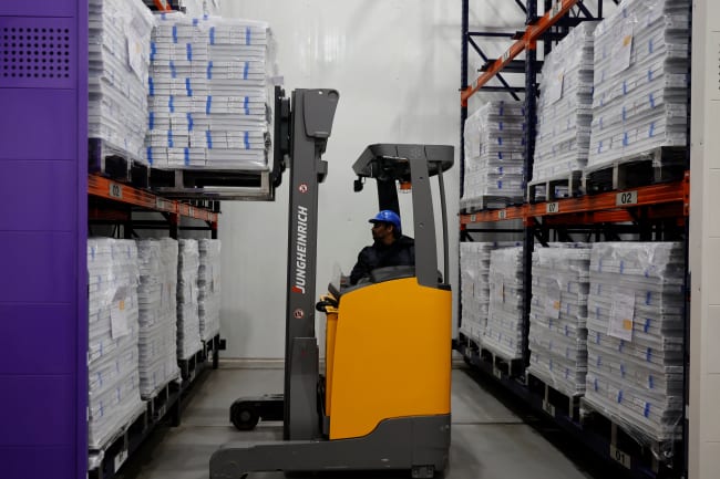 A forklift unloads boxes containing vials of the R21 malaria vaccine inside a cold room at the Serum Institute of India, in Pune, India, on February 27, 2024.