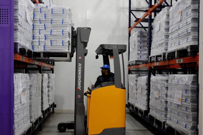 A forklift unloads boxes containing vials of the R21 malaria vaccine, inside a cold room, at the Serum Institute of India, in Pune, India, on February 27, 2024.