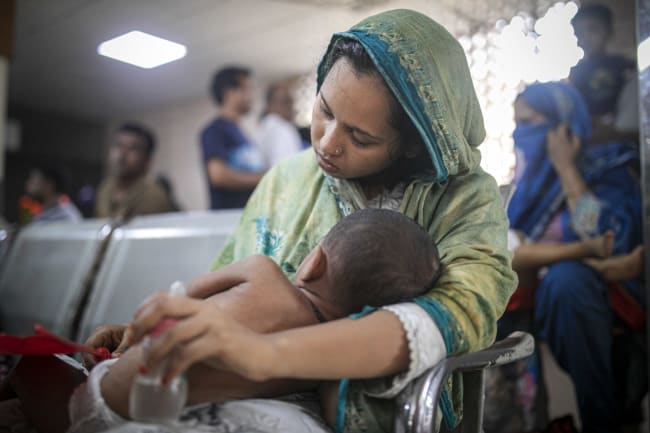 A mother waits to admit her measles‑affected child at Bangladesh Shishu Hospital in Dhaka, Bangladesh, on May 23, 2026.