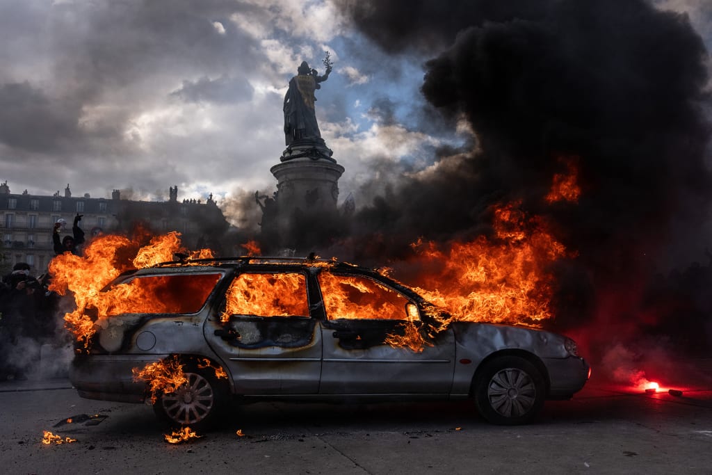 A car is set ablaze during demonstrations on October 17, 2026 in Paris, France. The involvement of the Gilets Jaunes (Yellow Vests) with the ongoing French school blockades expands the scope of these demonstrations by linking localised student grievances to broader economic policies. Student unions originally initiated the movement to protest underfunding, deteriorating infrastructure, and acute teacher shortages across French high schools and universities. By joining the protests, the Gilets Jaunes introduce their established platform against austerity cuts, rising living costs, and surging fuel prices into the youth-led action.