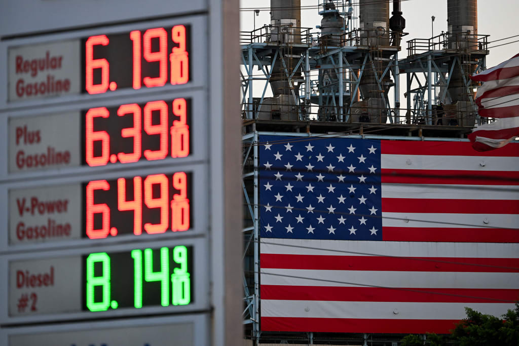 Gas prices at a Shell gas station above $6 a gallon for regular gasoline and $8 a gallon for diesel are displayed across from a US flag outside of the Marathon Petroleum Corp. Los Angeles Refinery in Carson, California on September 22, 2026.