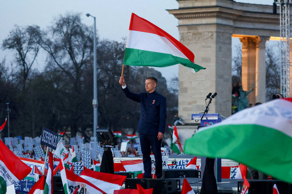 Peter Magyar, leader of the opposition Tisza party, holds a Hungarian flag during Hungary's National Day celebrations, which also commemorates the 1848 Hungarian Revolution against Habsburg rule, in Budapest, Hungary, on March 15, 2026.