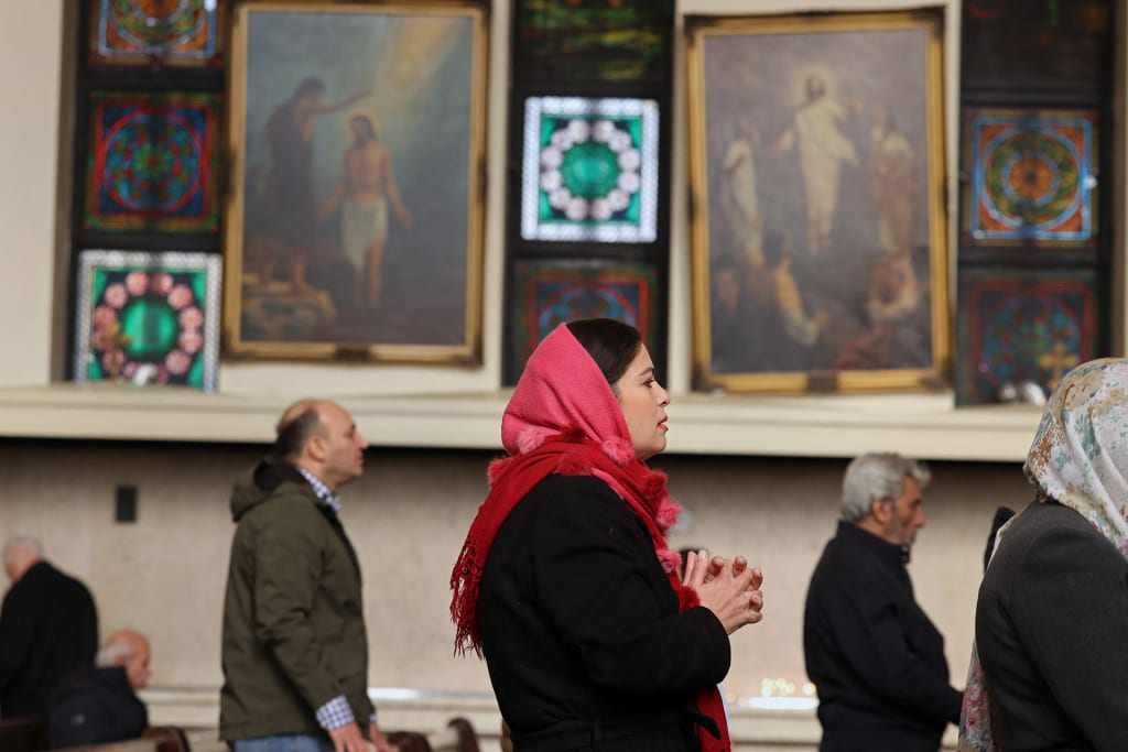 Iranian Christians attend a mass celebrating the Armenian Christmas at the Saint Sarkis Armenian Cathedral in Tehran on January 6, 2026.