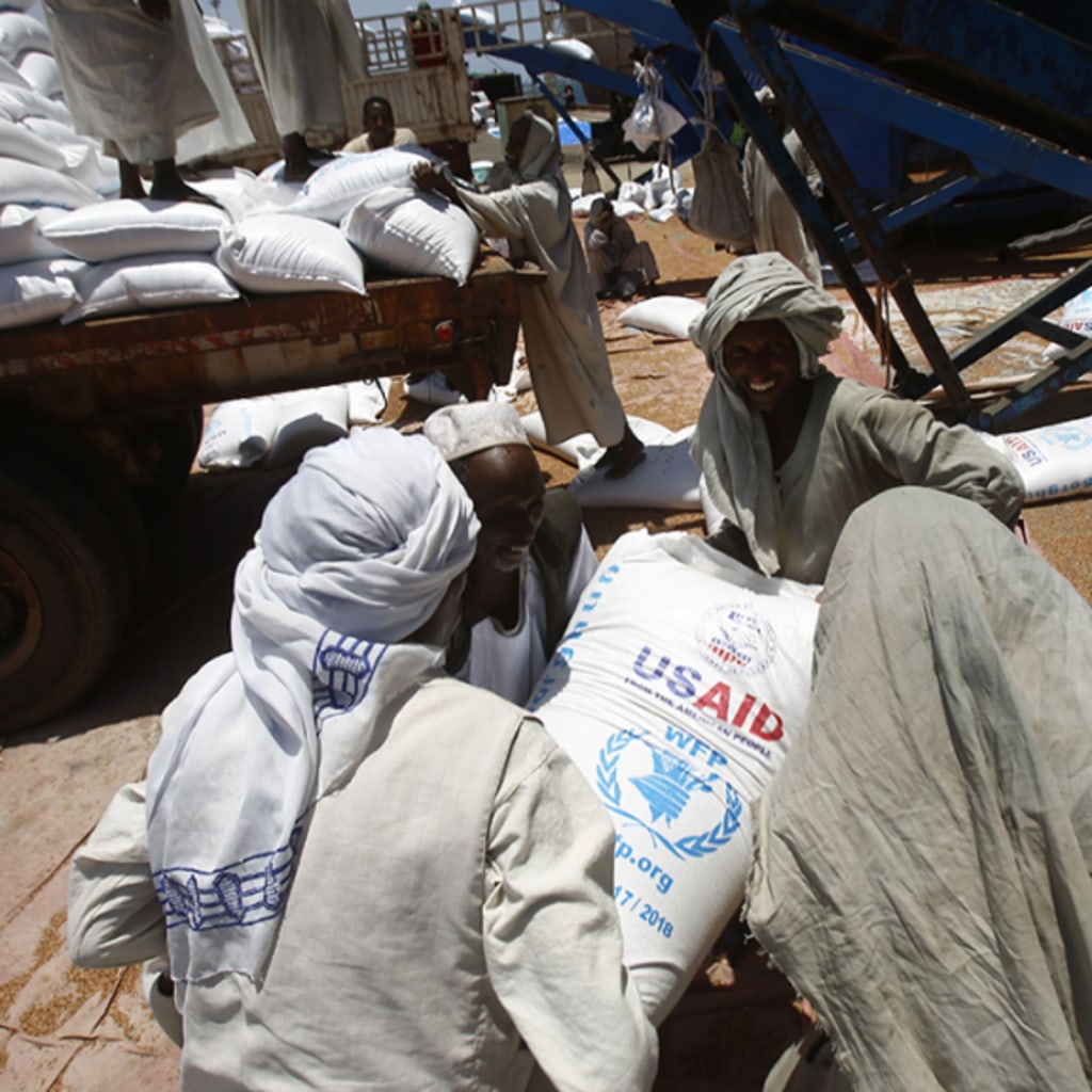 <p>Sudanese dockers unload bags of cereal from U.S. ships carrying humanitarian aid supplies provided by USAID, at Port Sudan on the Red Sea.</p>
