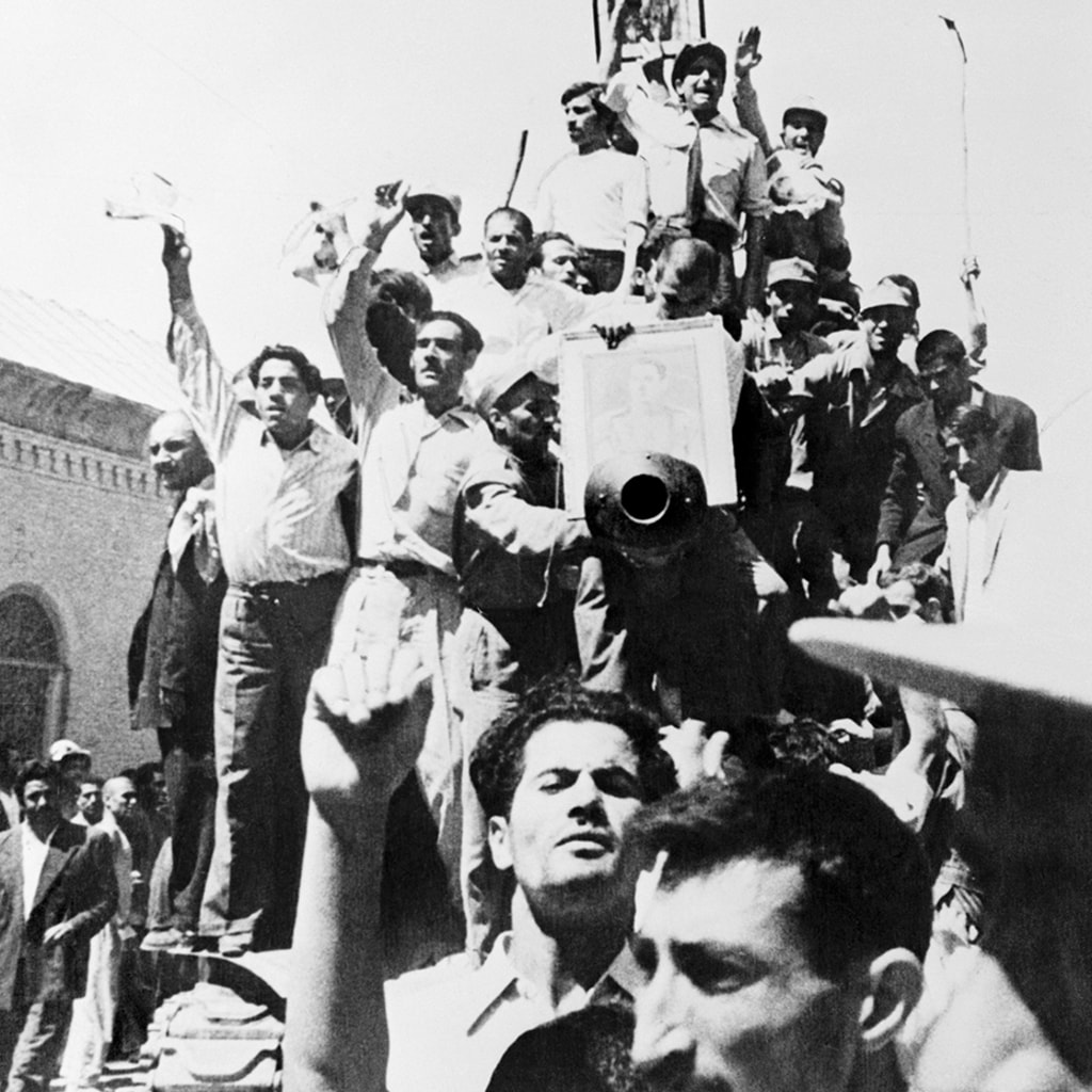 Iranians carry a portrait of the shah through the streets of Tehran after the overthrow of Prime Minister Mohammed Mossadeq. 
