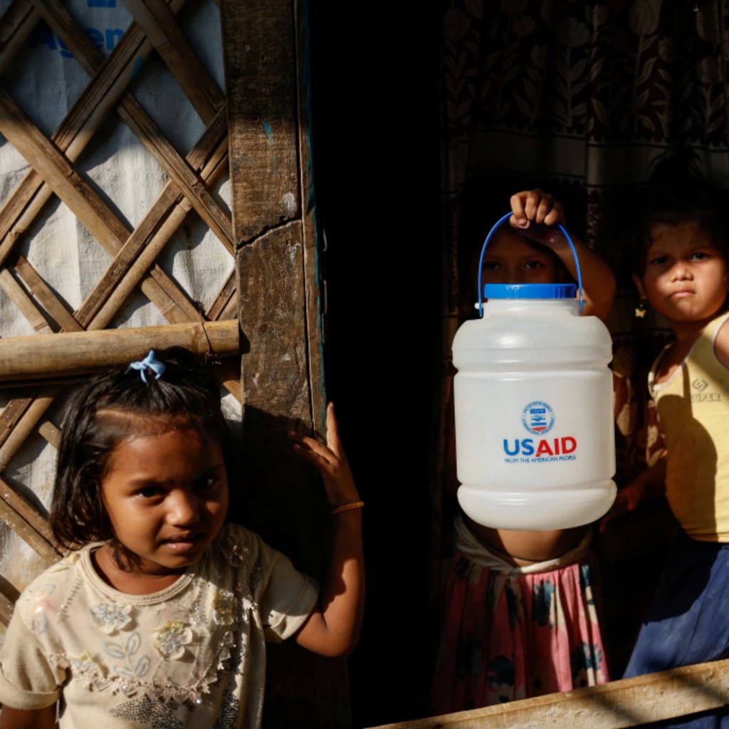 <p>A Rohingya refugee girl holds a jar with USAID logo imprinted at the refugee camp in Cox’s Bazar, Bangladesh on March 16, 2025.</p>