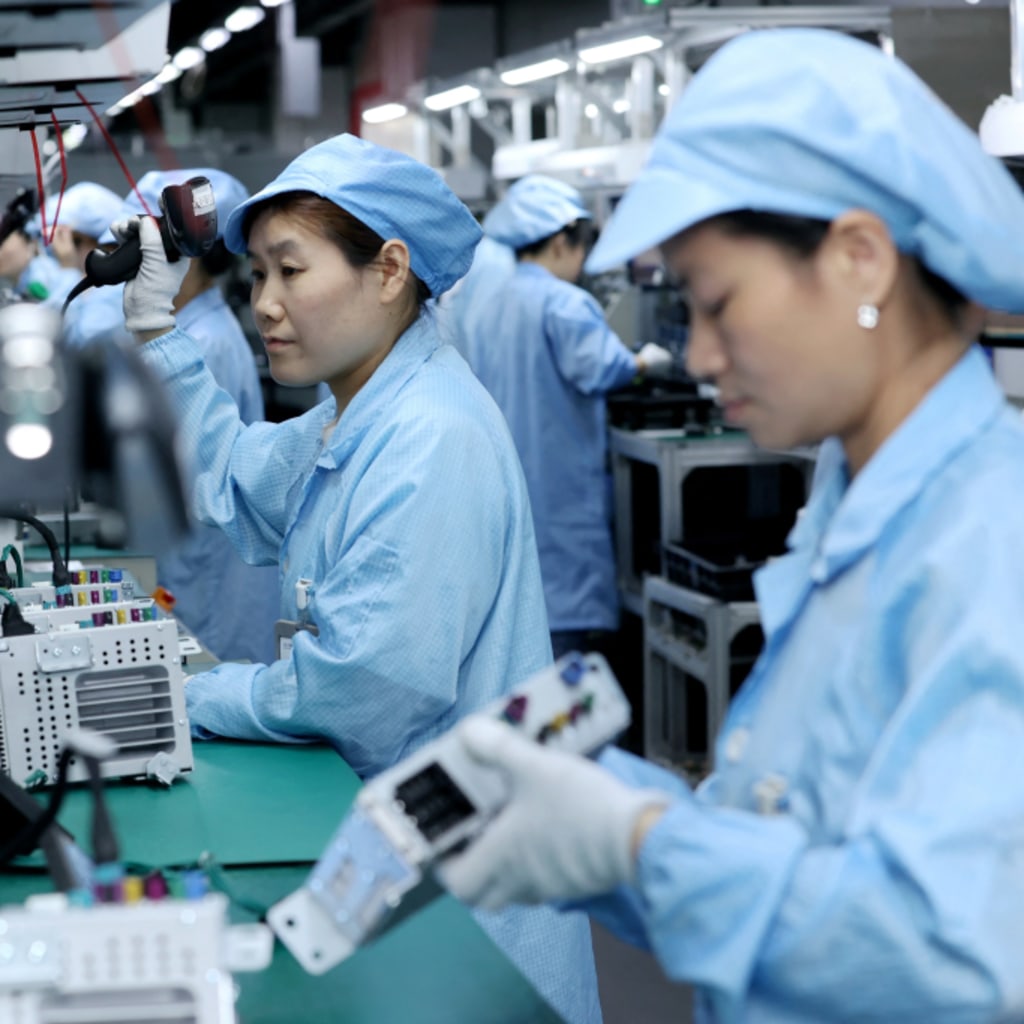 <p>Workers assembling automotive navigation products at a factory in Suqian, Jiangsu Province, China on April 9, 2025.</p>
