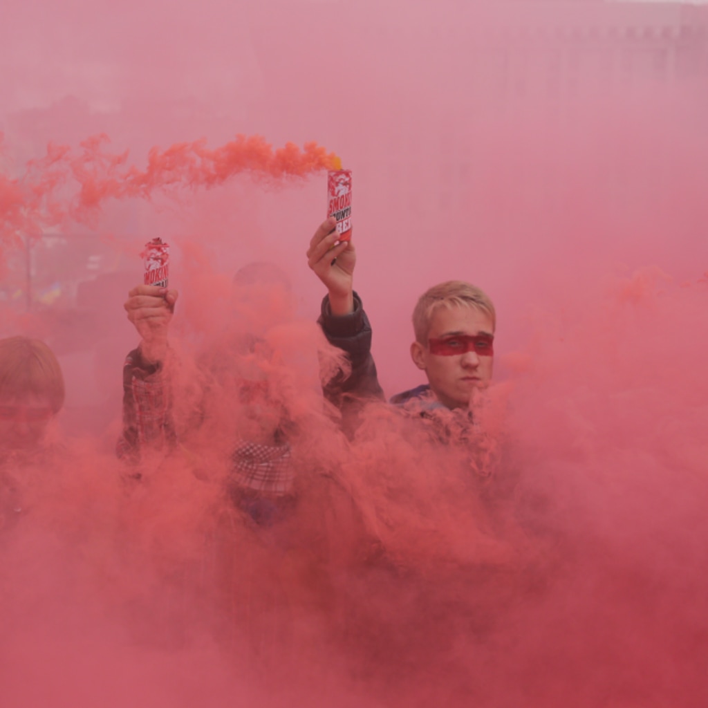 <p>People hold flares during a protest at Independence Square in Kyiv.</p>
