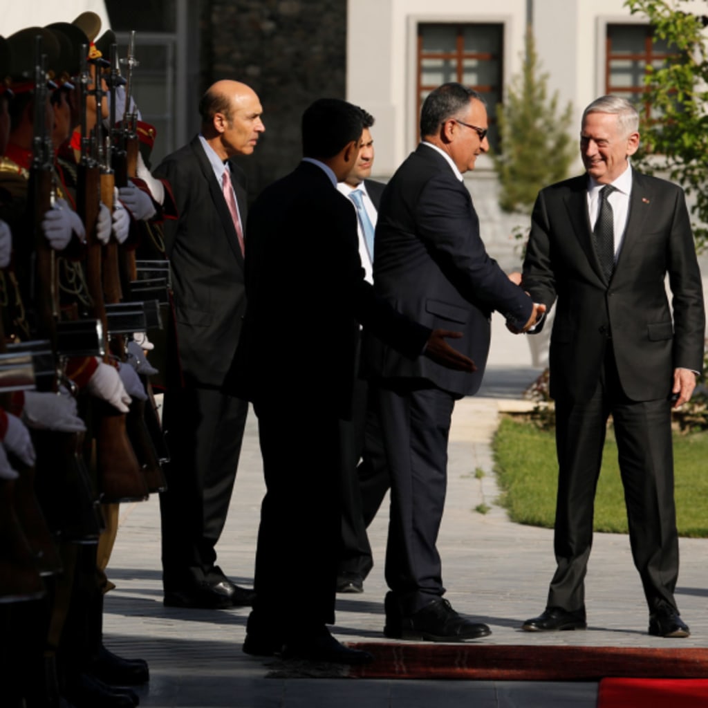 <p>U.S. secretary of defense James Mattis is greeted by Presidential Palace staff in Kabul, Afghanistan as he prepares to meet Afghan president Ashraf Ghani in April 2017.</p>
