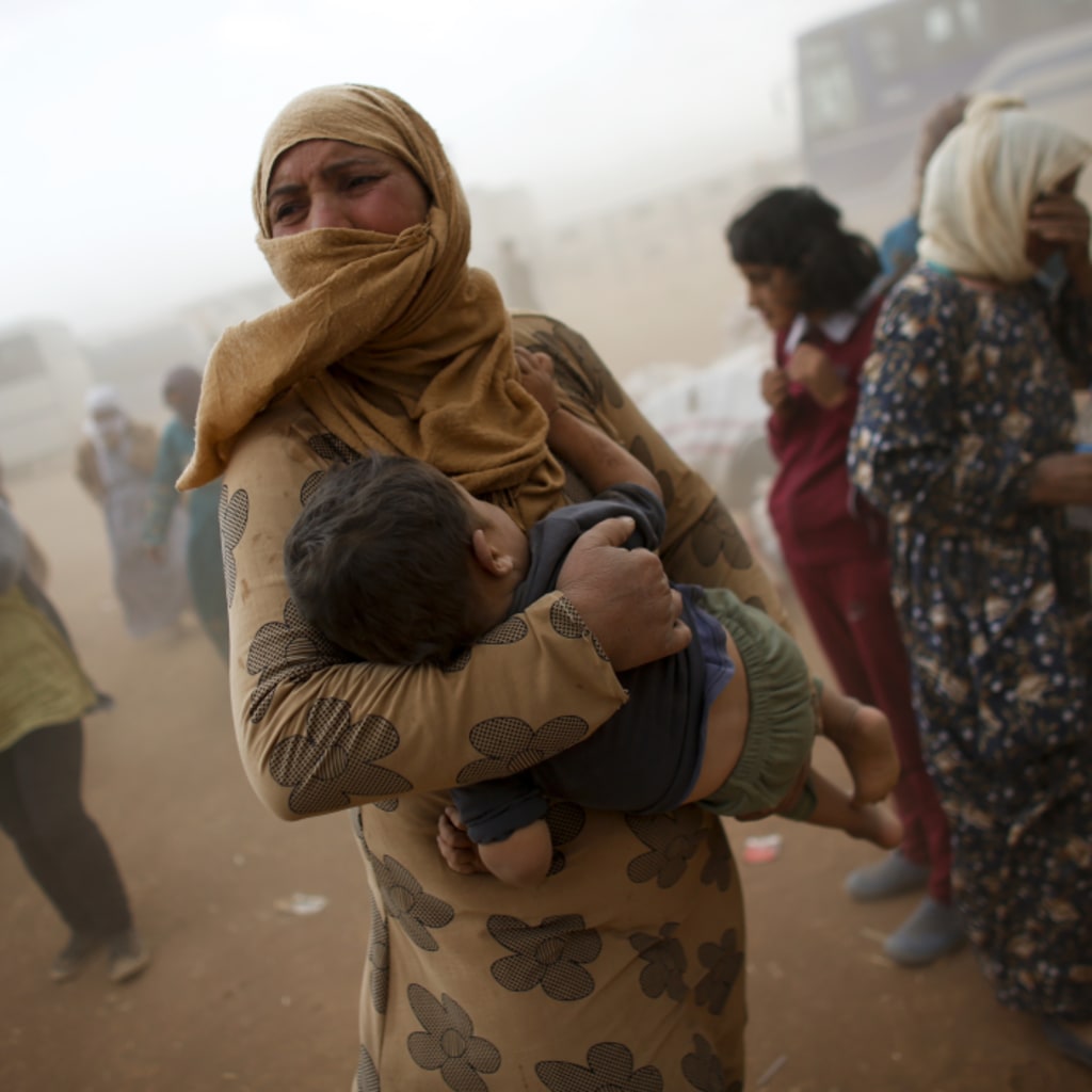 <p>A Kurdish Syrian refugee on the Turkey-Syria border.</p>
