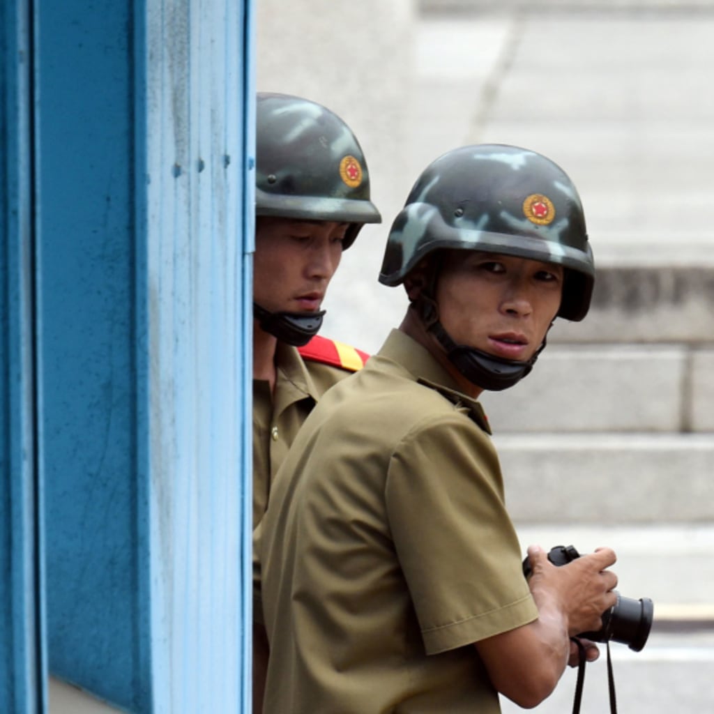 <p>North Korean soldiers at the demilitarized zone dividing the two Koreas.</p>
