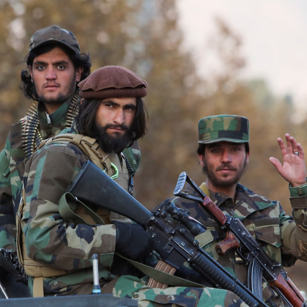 Members of Taliban sit on a military vehicle during Taliban military parade in Kabul