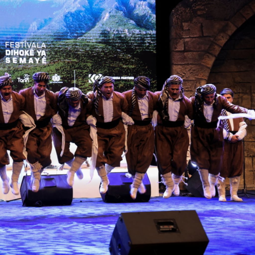 <p>Kurdish men in traditional folklore costumes perform during the Duhok Dance Festival in Duhok Province, Iraq. April 29, 2024.</p>