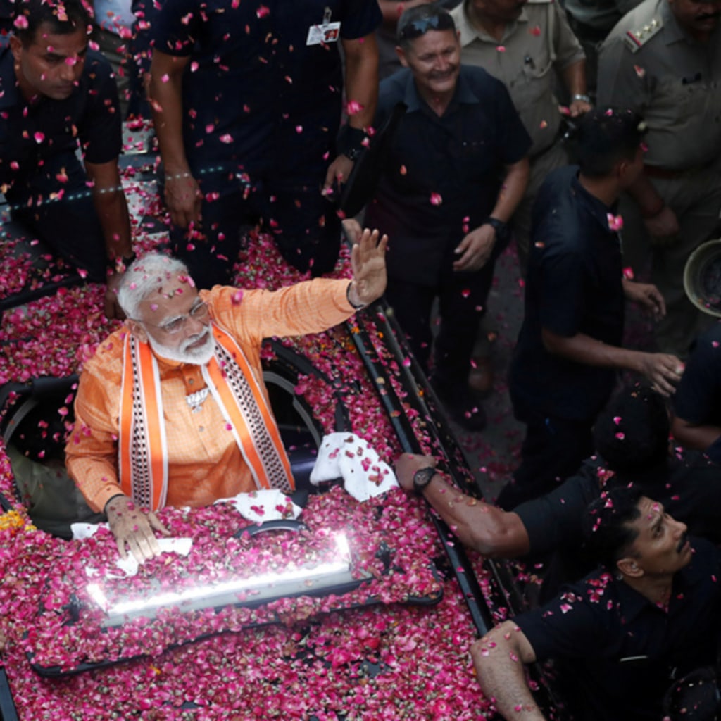 <p>India’s Prime Minister Narendra Modi waves towards his supporters during a roadshow in Varanasi, India.</p>