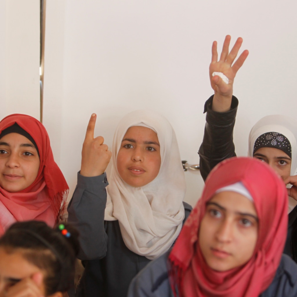 <p>Syrian refugee girls gesture as they sit inside a classroom at a school for Syrian refugee girls in Lebanon, October 19, 2017. </p>
