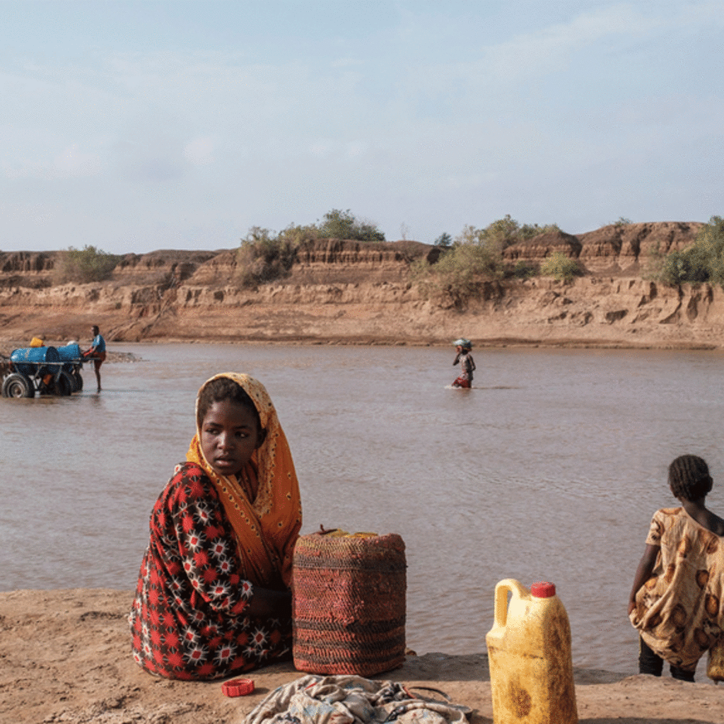 A girl looks on as she sits on the shore of the Shabelle river in the city of Gode, Ethiopia
