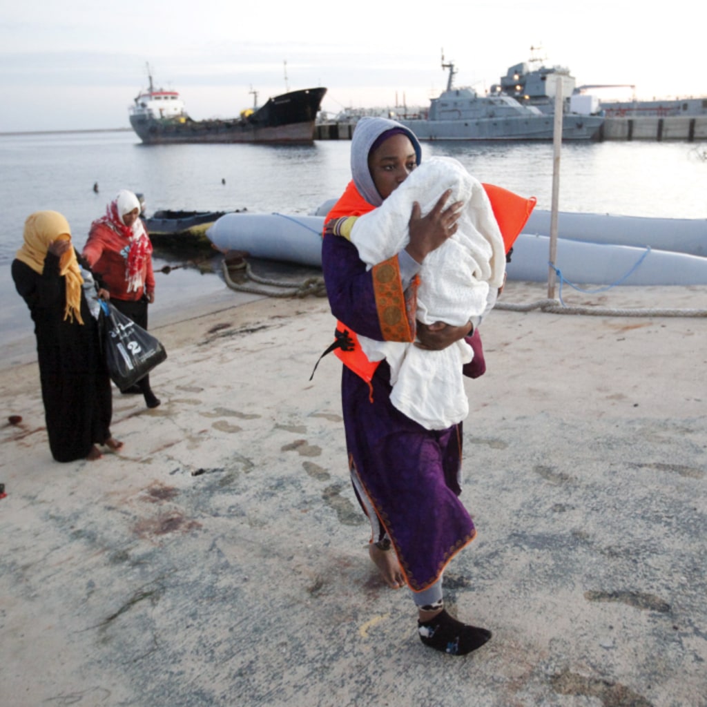 <p>Migrants disembark a Libyan Navy boat at a base in Tripoli, Libya, after they were stopped by Libyan coast guards. Libya has become a major hub for human traffickers smuggling African migrants by boat to Italy. September 29, 2015.</p>
