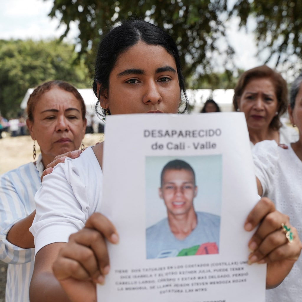 A woman holds a picture of a victim of forced disappearance during a 2025 ceremony in Colombia to honor loved ones who remain missing.