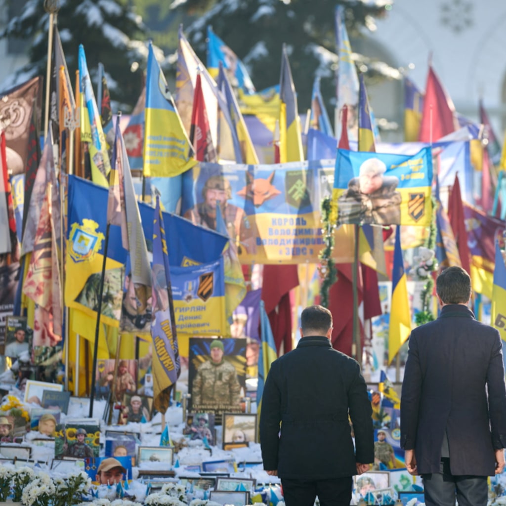 Ukrainian President Volodymyr Zelenskyy and NATO Secretary General Mark Rutte visit a makeshift memorial for fallen Ukrainian defenders in Kyiv, Ukraine. Ukrainian Presidential Press Service/Reuters