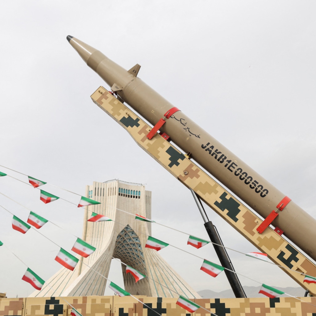 <p>Iranian flags hang next to a missile on display during the forty-seventh anniversary of the Islamic Revolution in Tehran, Iran, February 11, 2026.</p>
