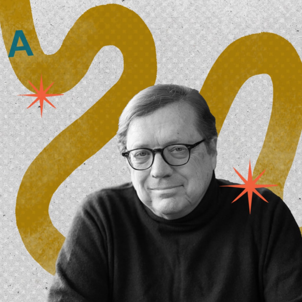 David Scheffer sits in front of yellow graphic.