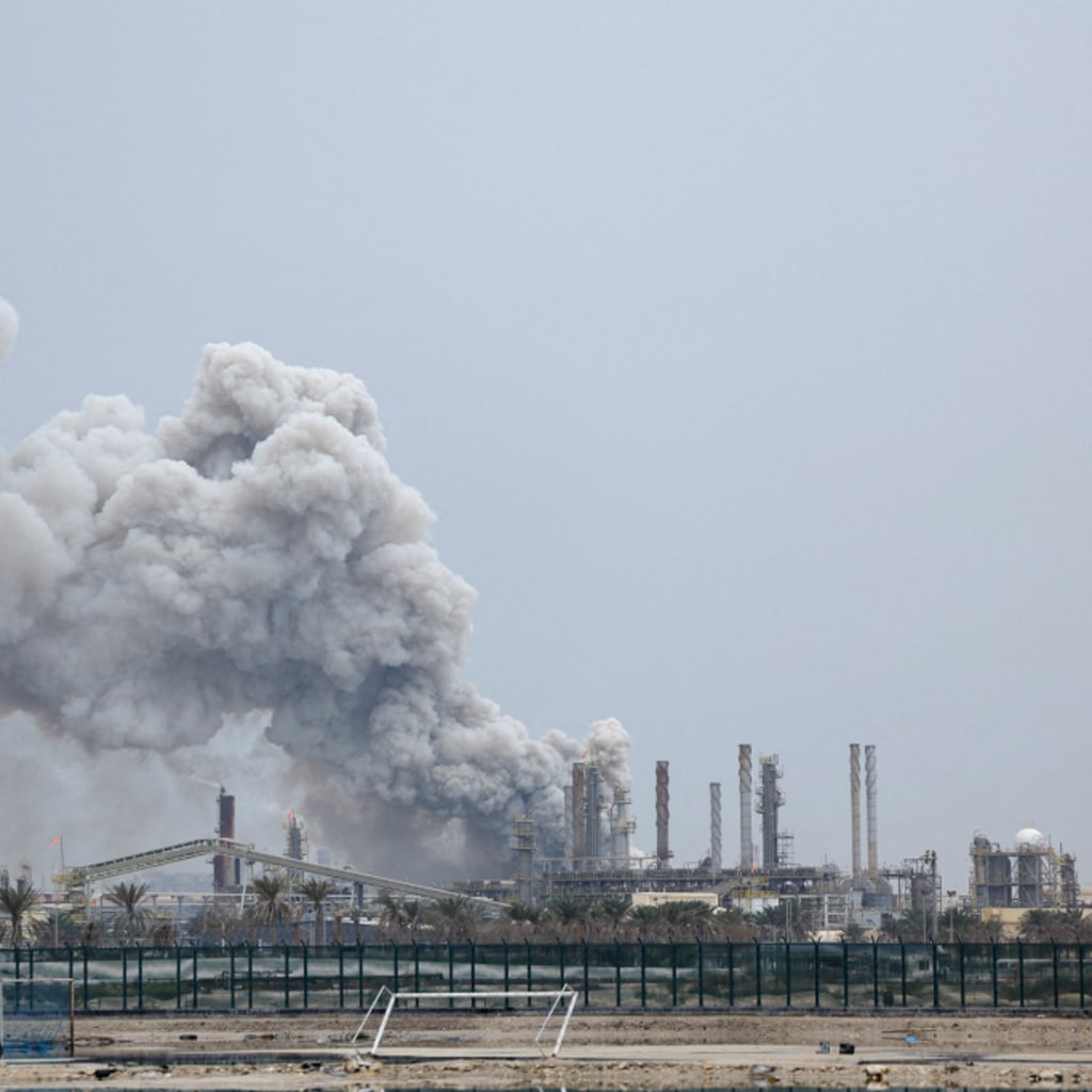 <p>A person rides on a scooter as smoke rises in the Fujairah oil industry zone following a fire caused by debris after interception of a drone by air defenses, in Fujairah, United Arab Emirates, March 3, 2026.</p>