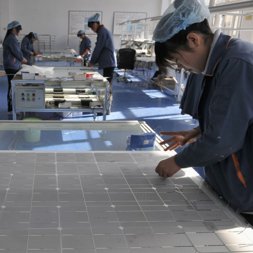 Employees work at the solar cells production line of the Blue Carbon Technology Inc. in Rizhao, Shandong province December 3, 2010. China is considering investments of up to $1.5 trillion over five years in seven strategic industries, sources said, a plan aimed at accelerating the country's transition from the world's supplier of cheap goods to a leading purveyor of high-value technologies. The targeted sectors include alternative energy, biotechnology, new-generation information technology, high-end equipment manufacturing, advanced materials, alternative-fuel cars and energy-saving and environmentally friendly technologies. REUTERS/Stringer (CHINA - Tags: ENERGY ENVIRONMENT BUSINESS) CHINA OUT. NO COMMERCIAL OR EDITORIAL SALES IN CHINA