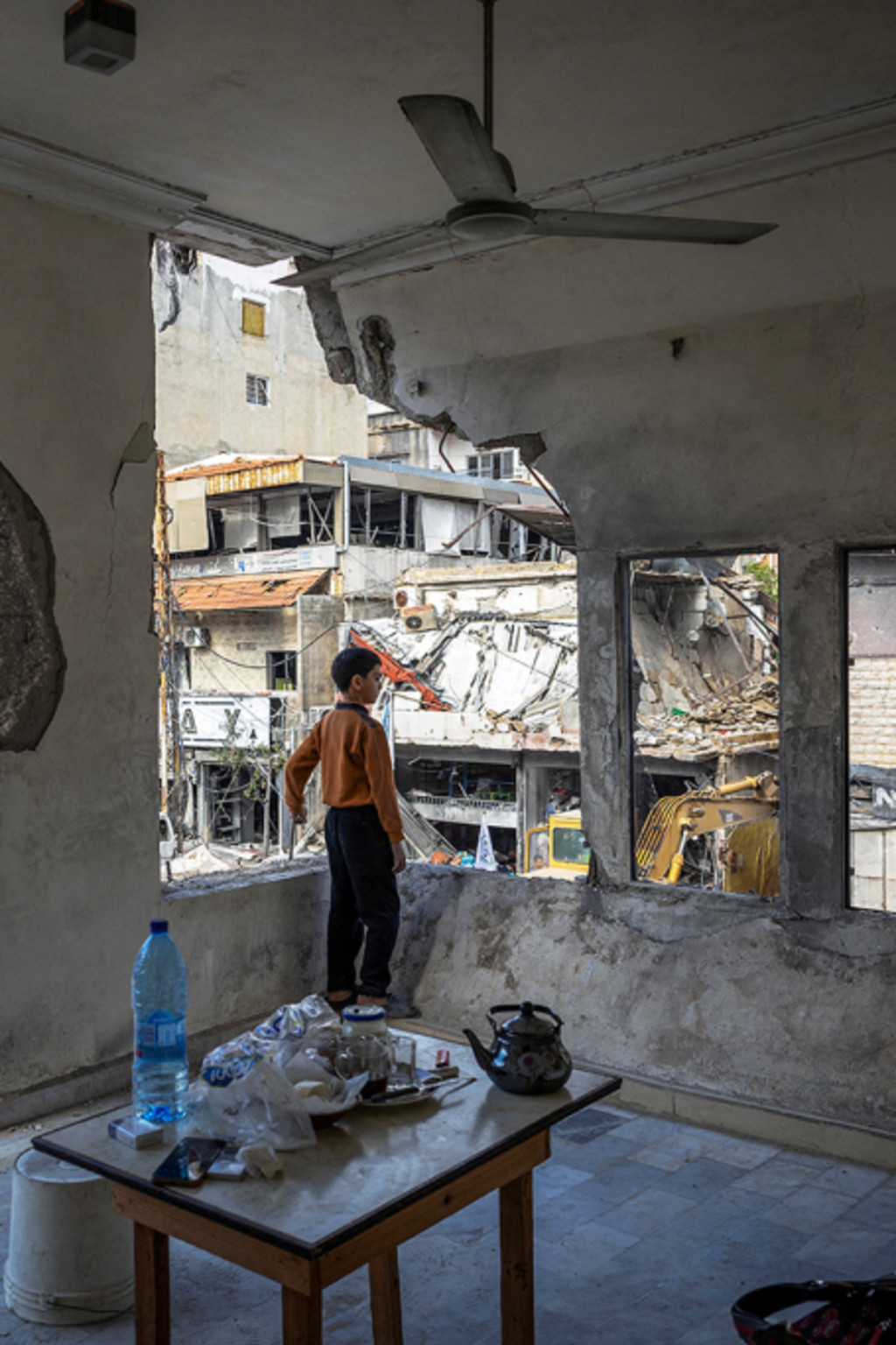 <p>A boy stands inside his damaged house in Tyre, Lebanon, in November 2024.</p>