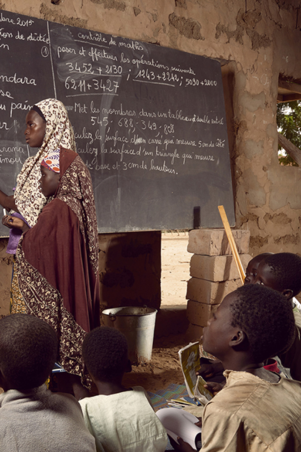 <p>Students use a converted prayer space as a classroom in Niger.</p>