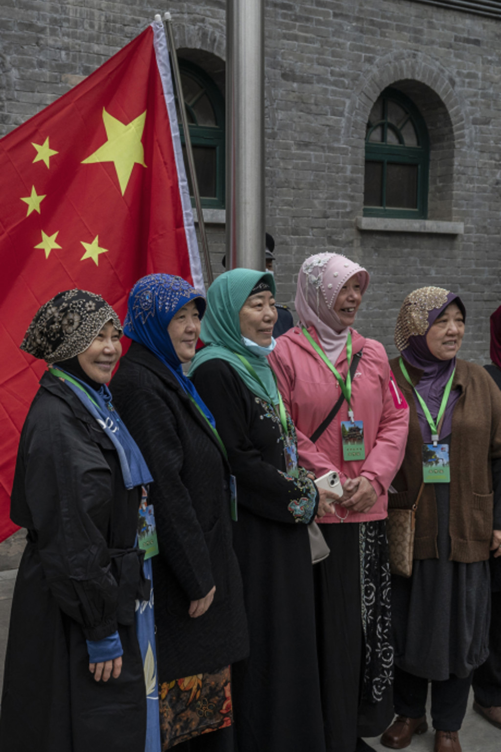 <p>Hui Muslim women stand in front of China’s flag at a mosque in Beijing.</p>
