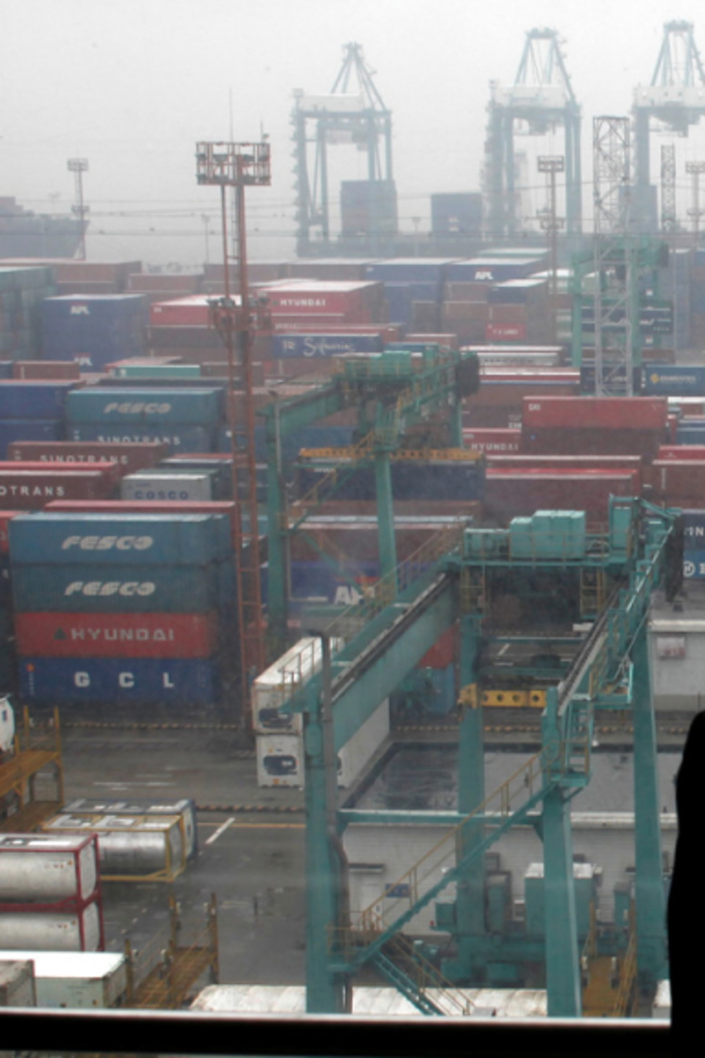 <p>An employee surveys shipping container traffic at the Port of Shanghai. </p>