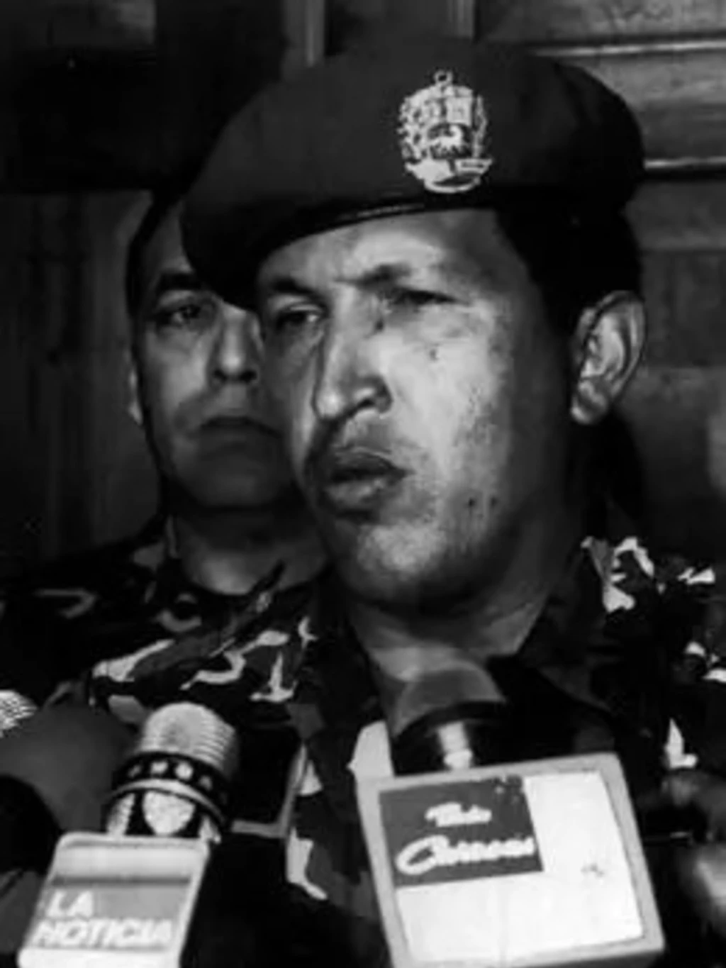 Chavez talks to reporters after surrendering to troops loyal to Perez. 