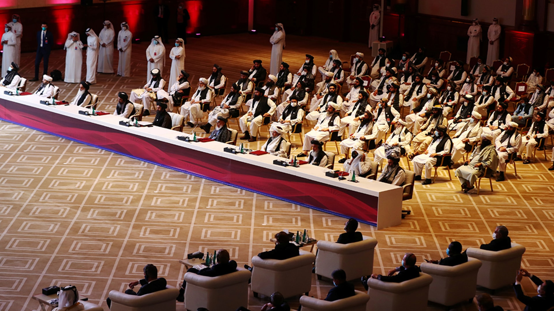 Delegates from the Afghan government and the Taliban attend talks in Doha. 
