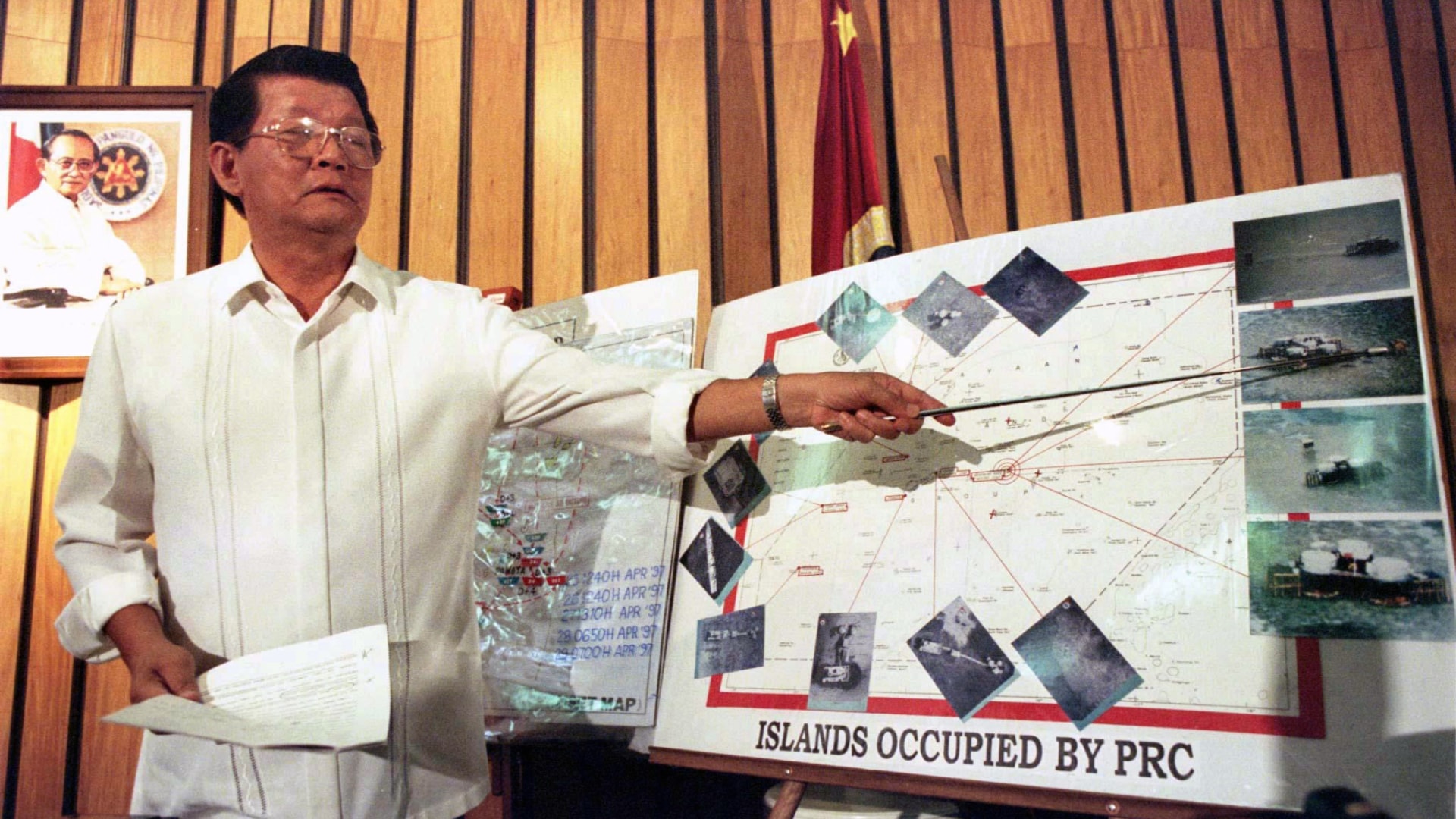 Former Philippine Secretary of National Defense Renato de Villa points out a Chinese-built structure in the disputed Spratly Islands. Reuters