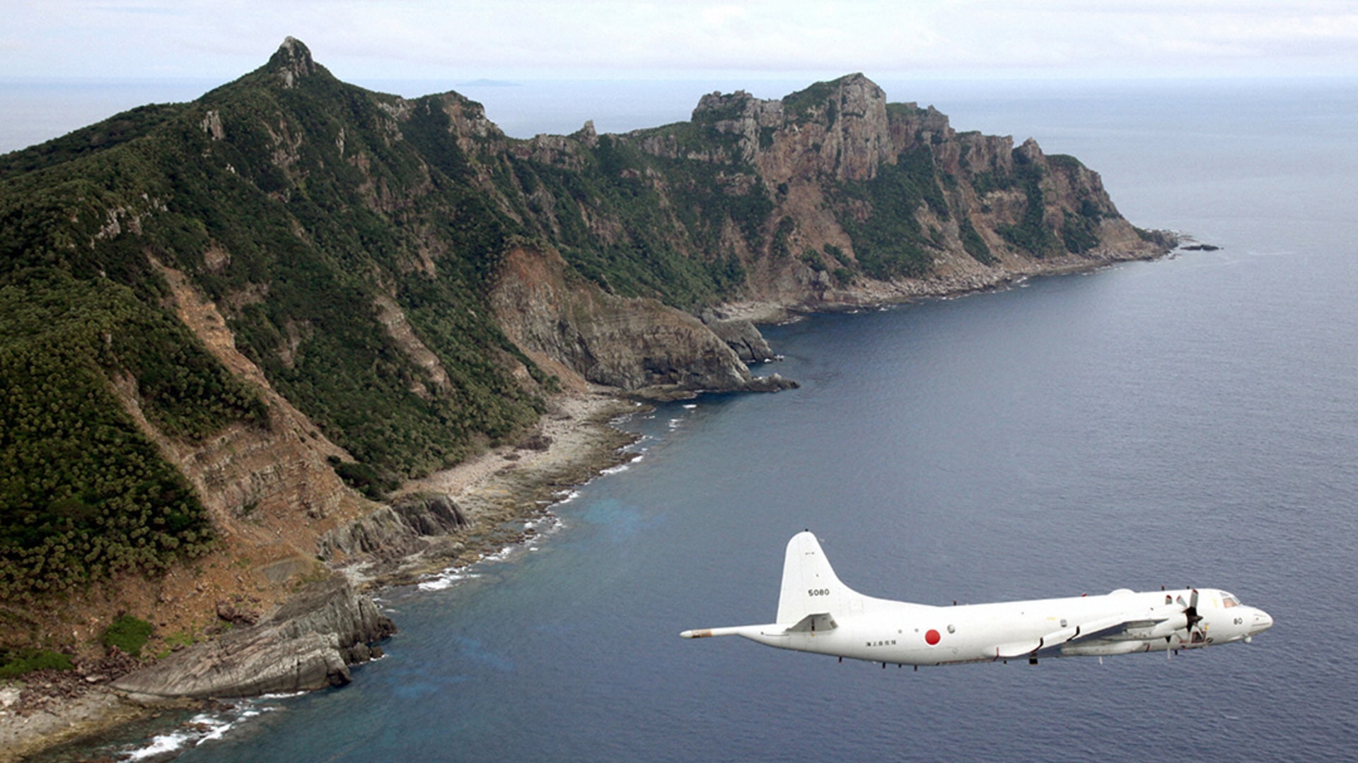 A Japan Maritime Self-Defense Force surveillance plane flies around the Senkaku/Diaoyu Islands in the East China Sea. Kyodo/Reuters