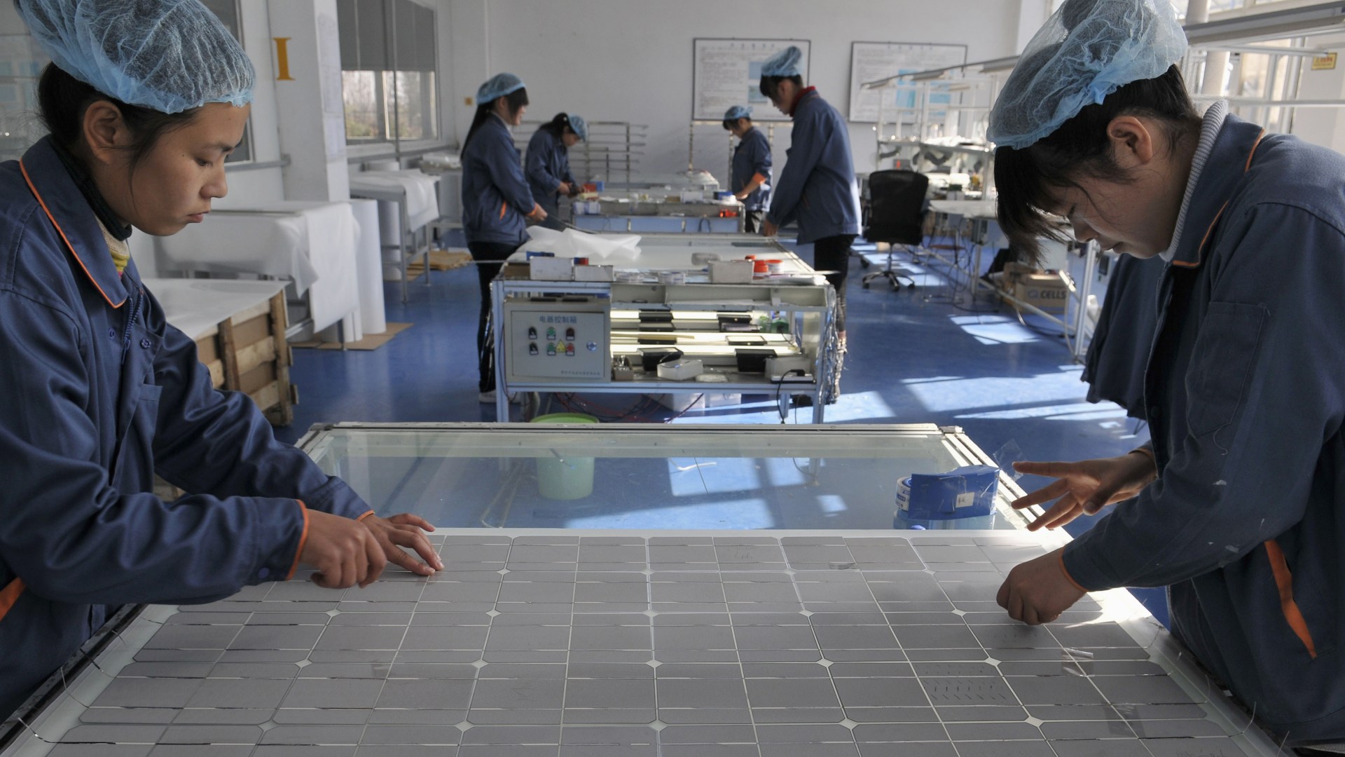 Employees work at the solar cells production line of the Blue Carbon Technology Inc. in Rizhao, Shandong province December 3, 2010. China is considering investments of up to $1.5 trillion over five years in seven strategic industries, sources said, a plan aimed at accelerating the country's transition from the world's supplier of cheap goods to a leading purveyor of high-value technologies. The targeted sectors include alternative energy, biotechnology, new-generation information technology, high-end equipment manufacturing, advanced materials, alternative-fuel cars and energy-saving and environmentally friendly technologies. REUTERS/Stringer (CHINA - Tags: ENERGY ENVIRONMENT BUSINESS) CHINA OUT. NO COMMERCIAL OR EDITORIAL SALES IN CHINA