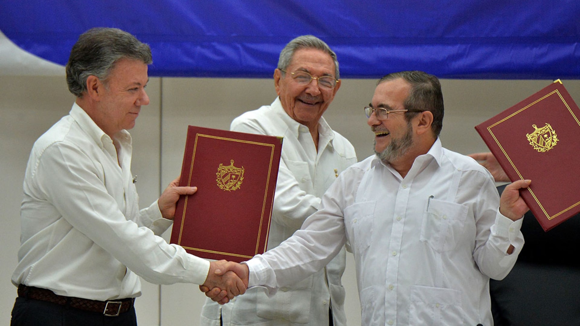 President Juan Manuel Santos shakes hands with FARC leader Timoleon Jimenez after signing a cease-fire deal in Havana, Cuba, on June 23, 2016. Adalberto Roque/AFP/Getty Images