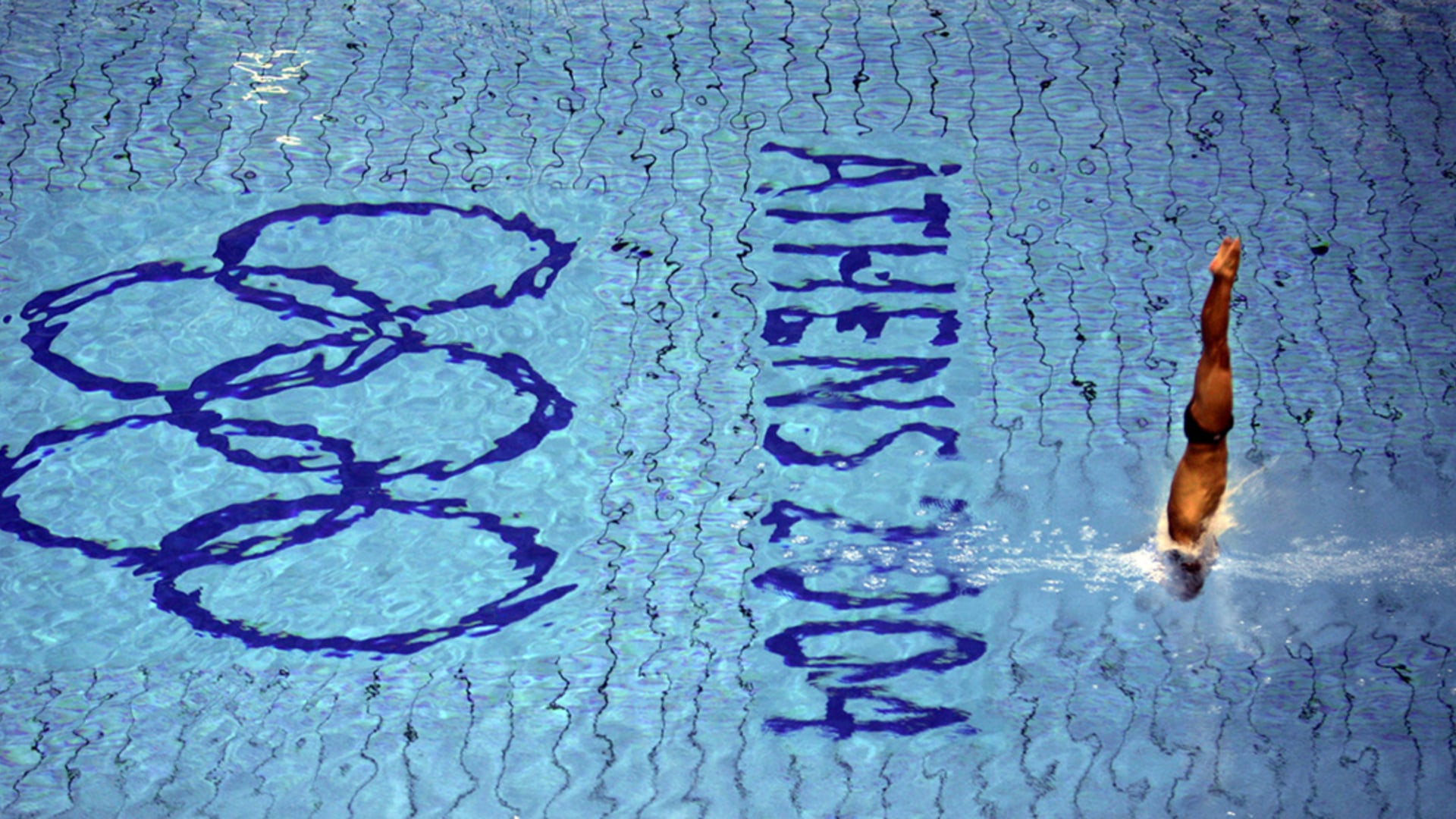 An athlete dives during a training session in the Olympic aquatic center in Athens ahead of the start of the 2004 Olympic Games. 
