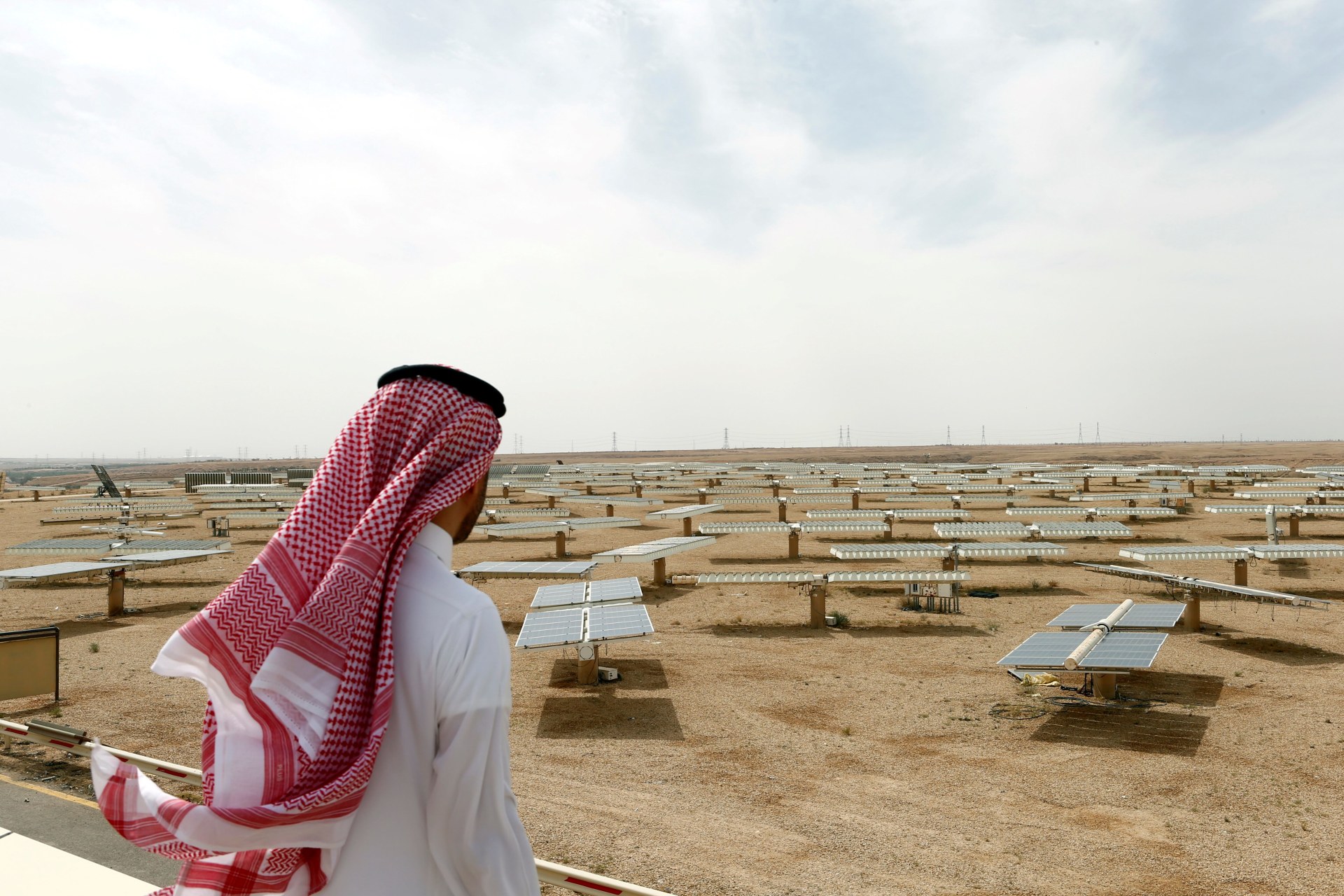 <p>Saudi man looks at the solar plant in Uyayna, north of Riyadh, Saudi Arabia</p>