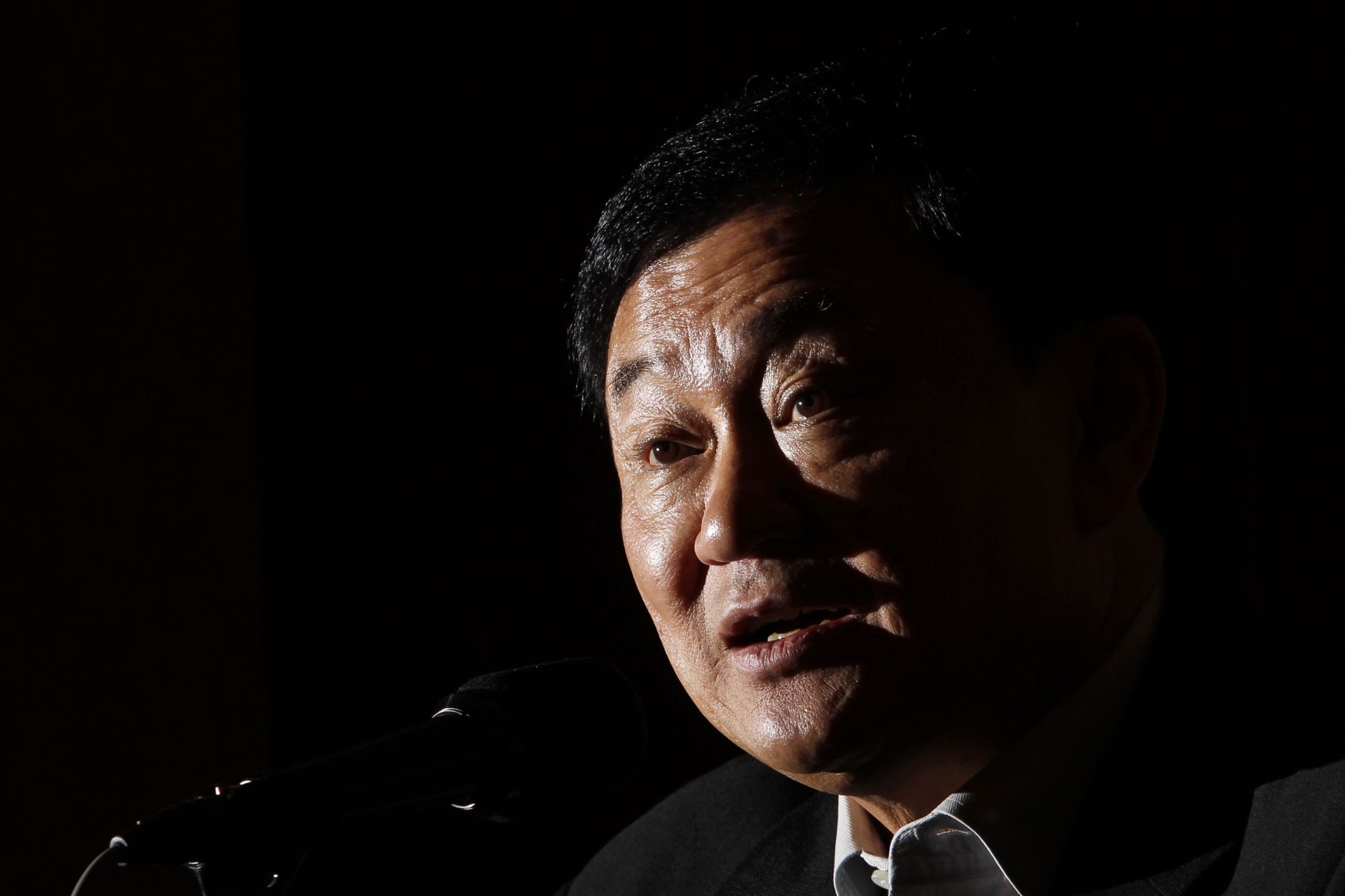 <p>Thailand’s former premier Thaksin Shinawatra speaks during a group interview in Tokyo in August 2011.</p>