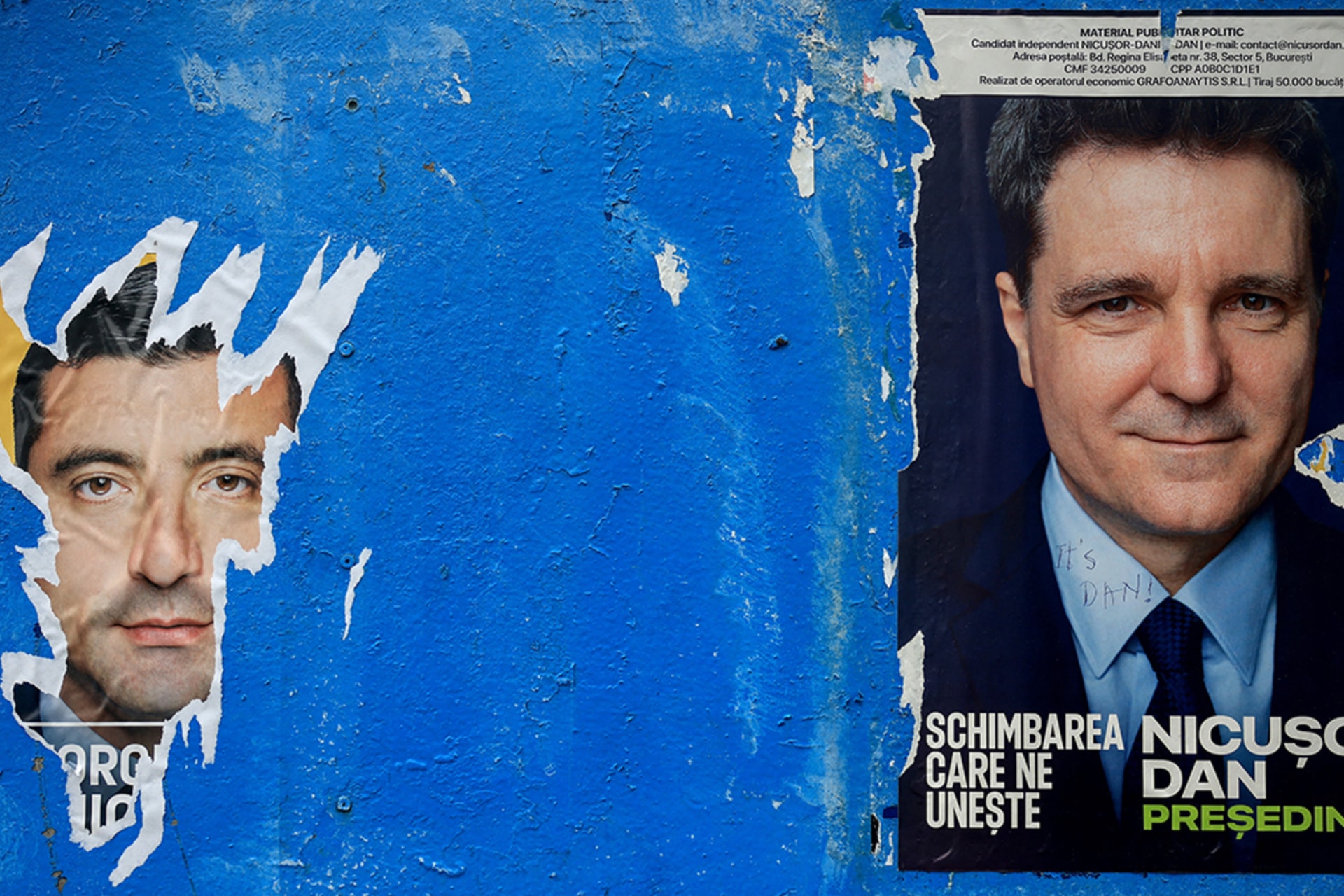 <p>A torn out poster featuring presidential candidate George Simion is seen next to one of Nicușor Dan, with the writing “It’s Dan”, ahead of the second round of the presidential elections, in Bucharest, Romania, May 16, 2025.</p>
