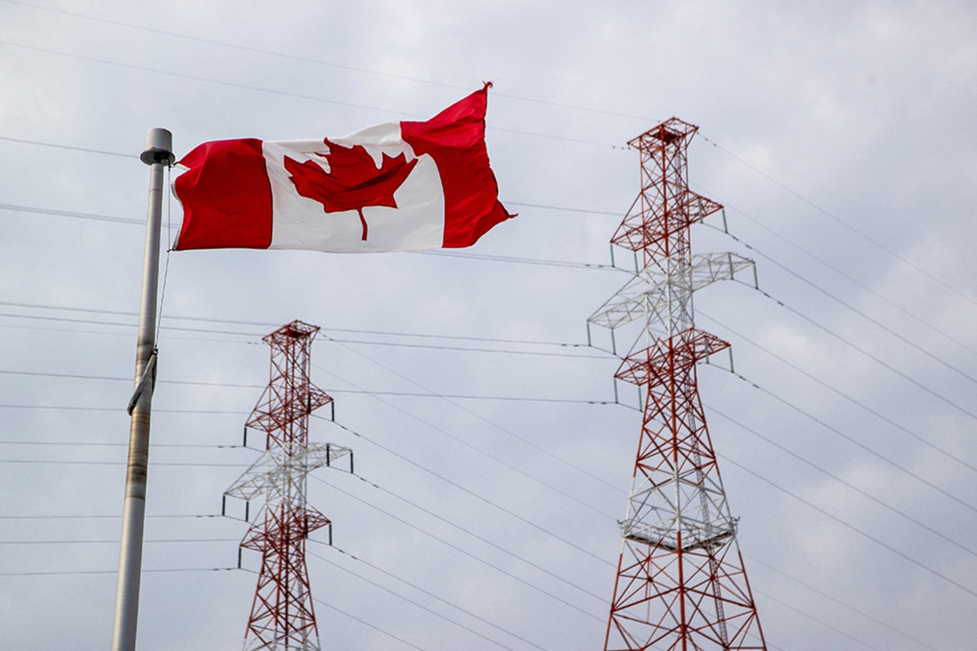 <p>A Canadian flag flutters as high voltage power lines cross from Canada to the U.S. near the RH Saunders Generating Station in Cornwall, Ontario, Canada March 11, 2025.</p>
